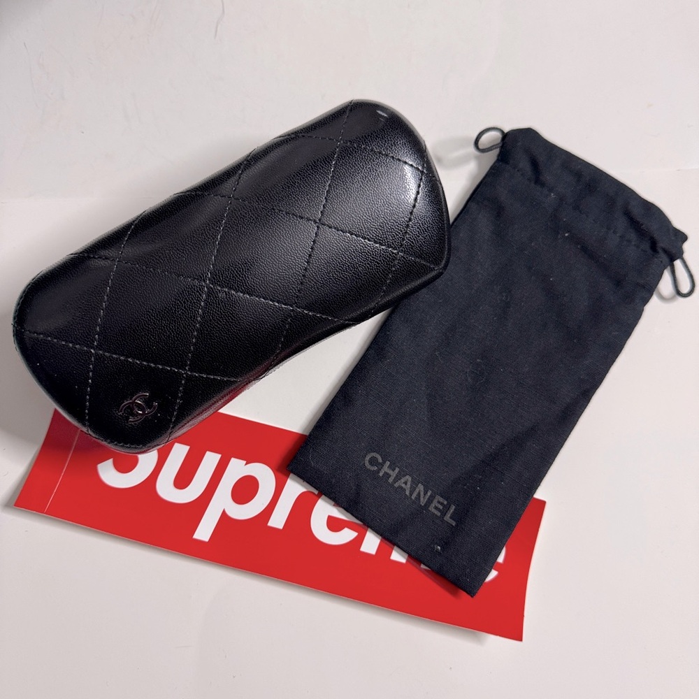 Chanel glasses case, dust bag and a supreme sticker bundle
